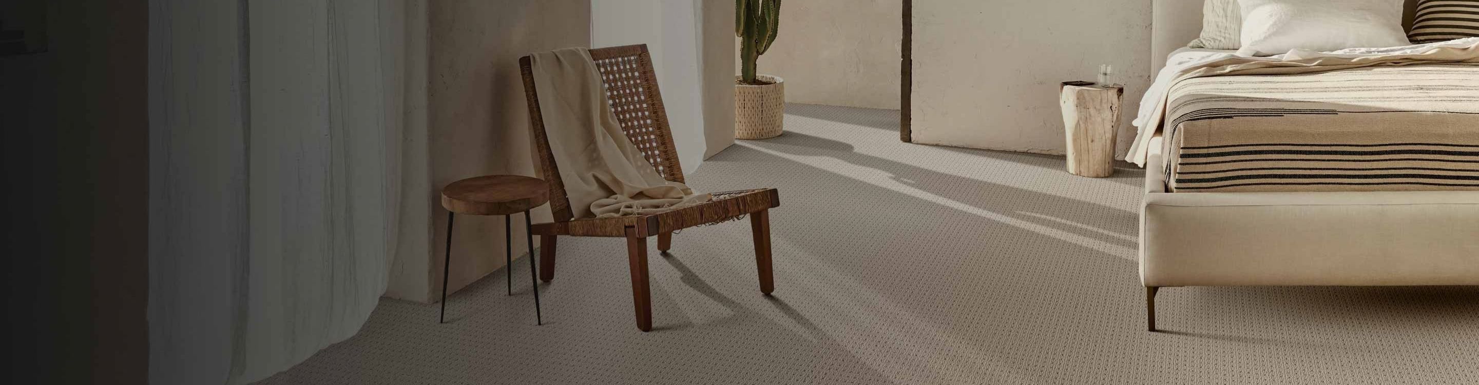 Living room with brown couch and two chairs, beige carpet