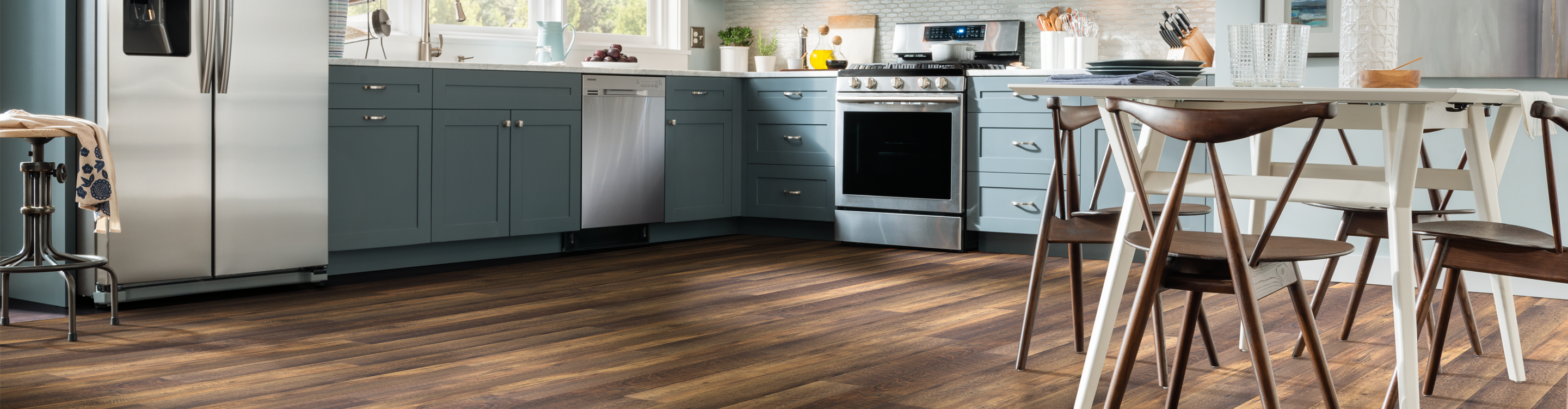 Dark vinyl planks with white kitchen set, flowers on table 